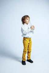 Image showing Pretty young boy in casual clothes on white studio background