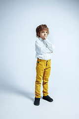 Image showing Pretty young boy in casual clothes on white studio background