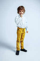 Image showing Pretty young boy in casual clothes on white studio background