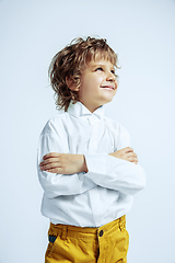 Image showing Pretty young boy in casual clothes on white studio background