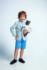 Image showing Pretty young boy in casual clothes on white studio background