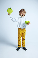 Image showing Pretty young boy in casual clothes on white studio background