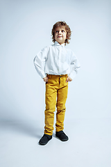 Image showing Pretty young boy in casual clothes on white studio background