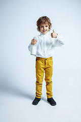 Image showing Pretty young boy in casual clothes on white studio background