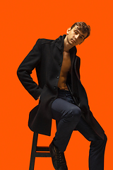 Image showing Portrait of a handsome young man on orange background