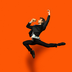 Image showing Man in casual office style clothes jumping isolated on studio background