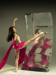 Image showing Young and stylish modern ballet dancer on brown background