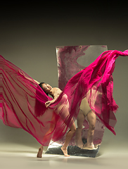 Image showing Young and stylish modern ballet dancer on brown background