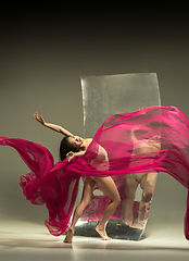 Image showing Young and stylish modern ballet dancer on brown background