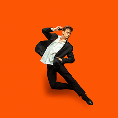 Image showing Man in casual office style clothes jumping isolated on studio background