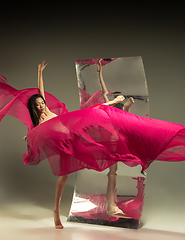 Image showing Young and stylish modern ballet dancer on brown background