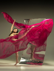 Image showing Young and stylish modern ballet dancer on brown background