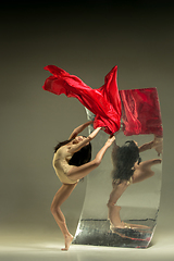 Image showing Young and stylish modern ballet dancer on brown background