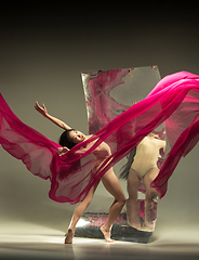 Image showing Young and stylish modern ballet dancer on brown background