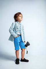 Image showing Pretty young boy in casual clothes on white studio background