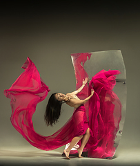 Image showing Young and stylish modern ballet dancer on brown background