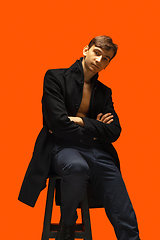 Image showing Portrait of a handsome young man on orange background
