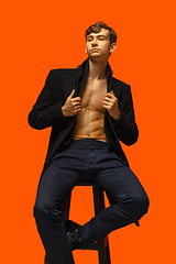 Image showing Portrait of a handsome young man on orange background