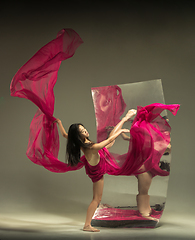 Image showing Young and stylish modern ballet dancer on brown background