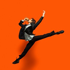 Image showing Man in casual office style clothes jumping isolated on studio background