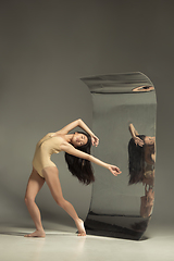 Image showing Young and stylish modern ballet dancer on brown background