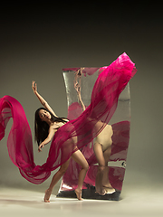 Image showing Young and stylish modern ballet dancer on brown background