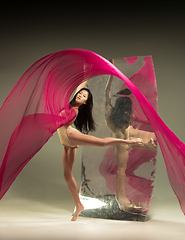 Image showing Young and stylish modern ballet dancer on brown background