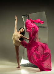 Image showing Young and stylish modern ballet dancer on brown background