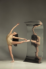Image showing Young and stylish modern ballet dancer on brown background