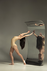 Image showing Young and stylish modern ballet dancer on brown background