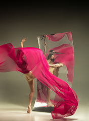 Image showing Young and stylish modern ballet dancer on brown background