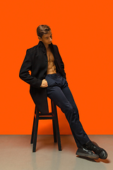 Image showing Portrait of a handsome young man on orange background