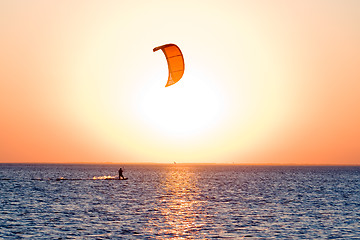 Image showing Silhouette of a kitesurfer on a gulf on a sunset