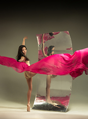 Image showing Young and stylish modern ballet dancer on brown background