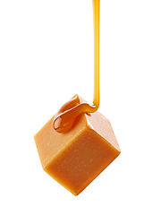 Image showing caramel sauce flowing on flying caramel candy