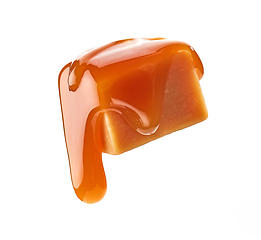 Image showing caramel sauce flowing on flying caramel candy