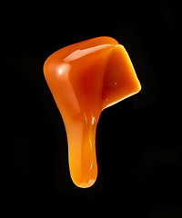 Image showing caramel sauce flowing on flying caramel candy