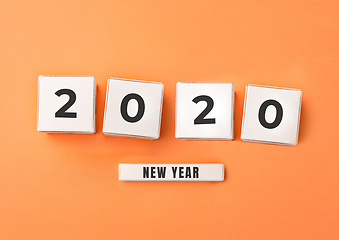 Image showing 2020 made from white boxes with numbers on orange studio background