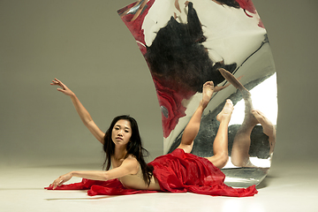 Image showing Young and stylish modern ballet dancer on brown background