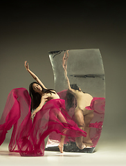 Image showing Young and stylish modern ballet dancer on brown background