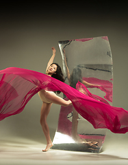 Image showing Young and stylish modern ballet dancer on brown background