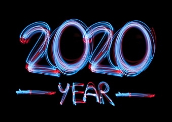 Image showing 2020 in neon multi colour, parallel lines pattern on black background