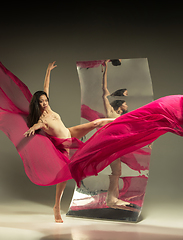 Image showing Young and stylish modern ballet dancer on brown background