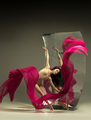 Image showing Young and stylish modern ballet dancer on brown background