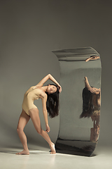 Image showing Young and stylish modern ballet dancer on brown background