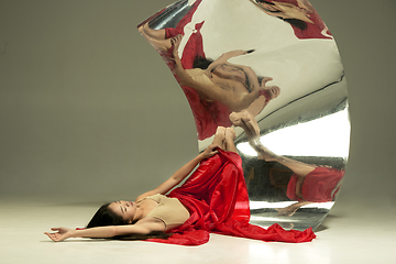 Image showing Young and stylish modern ballet dancer on brown background