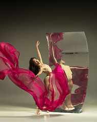 Image showing Young and stylish modern ballet dancer on brown background