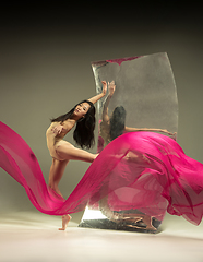 Image showing Young and stylish modern ballet dancer on brown background