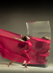 Image showing Young and stylish modern ballet dancer on brown background