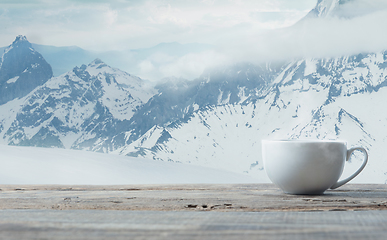 Image showing Single tea or coffee mug and landscape of mountains on background